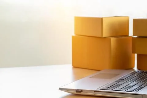 Shopping online concept, Notebook computer placed the side the parcel box, Co Stock Photos
