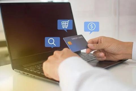 Shopping online with a notebook computer Pay goods via credit card Conveniently Stock Photos