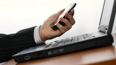 Shopping online using cell phone and laptop Stock Footage 837740