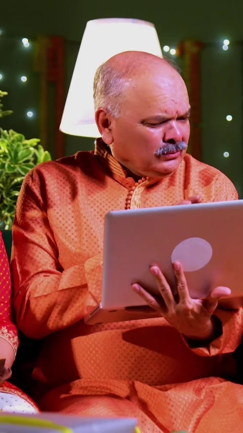 Shopping online using laptop, Indian family celebrates Diwali night Stock-Footage 342345958