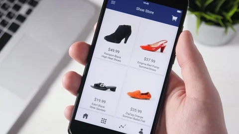 Shopping online using smartphone app and choosing shoes Stock Footage 89724065