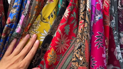 Shopping. Person explores a rich array of clothes. Vibrant clothes concept 스톡 동영상 339040458