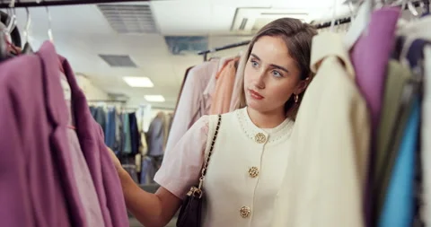 Shopping, selection and customer in store with clothes, outfit search and Stock Footage 345655340