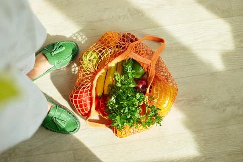 Shopping string grocery reusable mesh bag full of fresh fruits and vegetables Stock Photos