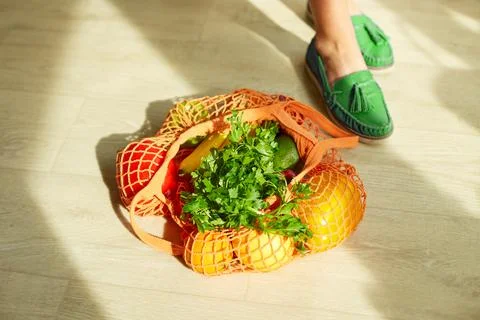 Shopping string grocery reusable mesh bag full of fresh fruits and vegetables Stock Photos