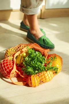 Shopping string grocery reusable mesh bag full of fresh fruits and vegetables Stock Photos