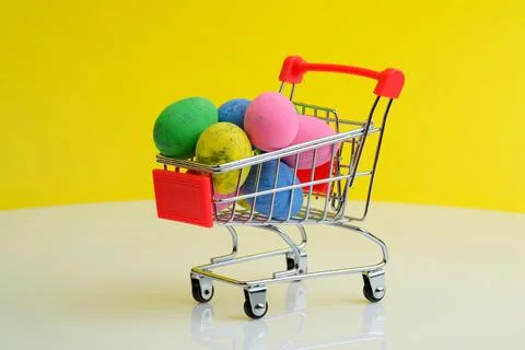 Shopping trolley with Easter eggs Stock Photos