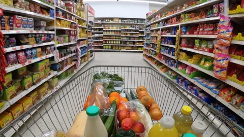 Shoppping trolley of generic groceries moving down supermarket aisle. Stock Footage 229402464