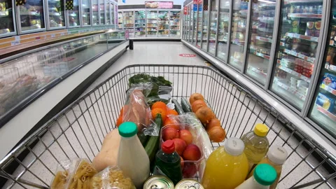 Shoppping trolley of generic groceries moving down supermarket aisle. Stock Footage 229402772