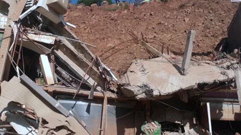 Shops and Hotel Damaged Due to Landslide Along National Highway Stockbeeldmateriaal 322929809