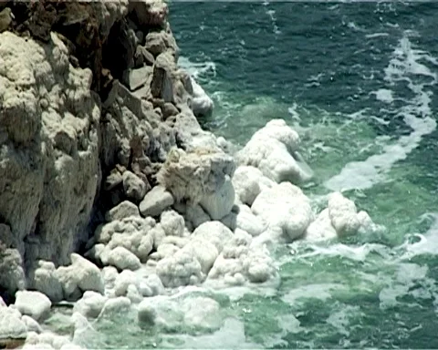 Shore of Dead Sea from Jordan side. Rocks are covered with white salt crystals Stock Footage 120777231
