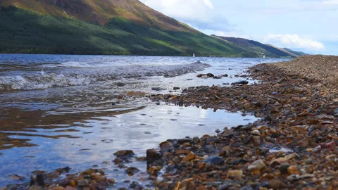 A shore of a mountain lake with small waves. Stock Footage 112684116