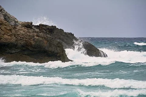 Shore rocks battered by waves Stock Photos
