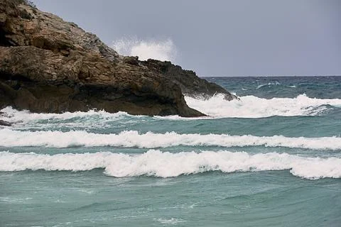 Shore rocks battered by waves, storm in the sea Stock Photos