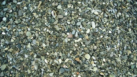 Shore of small pebbles of different colors Видео 168683428