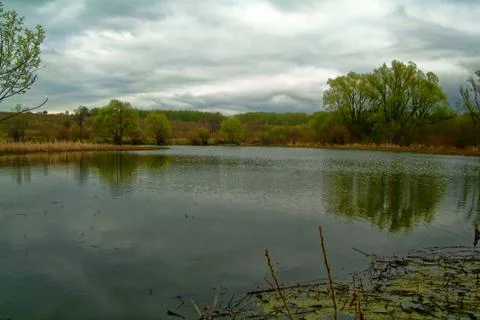 Shore of a small river on a spring evening Stock Photos