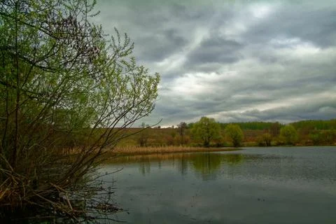 Shore of a small river on a spring evening Stock Photos