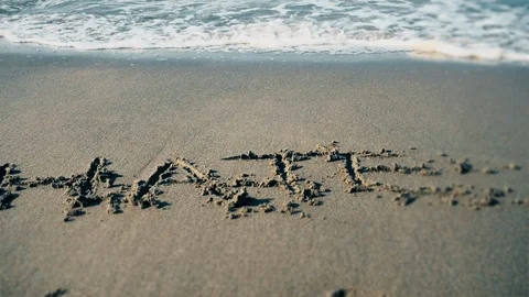 Shore. Text "HATE" on Beach Washed Away Stock Footage 95405037