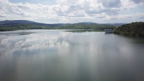 Shore of water reservoir with forest under blue sky at sunny summer day Stock Footage 121343553