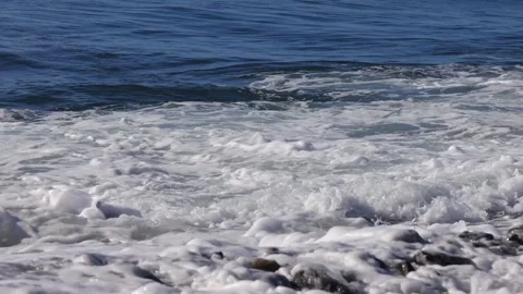 In shore waves crashing against wind .Blue sky, fierce, tumbling foam wave view, Stock Footage 277962959