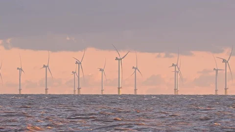 Off shore wind farm in early morning pink light and cloud. Stock Footage 120357553