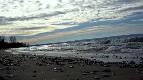 Shoreline beach view of waves rolling in Stock Footage 144903297