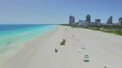 Shoreline of empty Miami Beach facing south hovering over sandy area 動画素材 130327435
