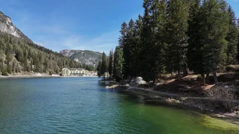 Shoreline View of Alpine Lake Bordered by Pines and Crags Stock Footage 341650878