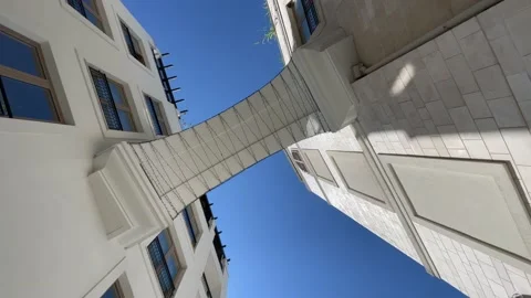 Short arch walkway between modern houses, against the sky. Stock Footage 202570681