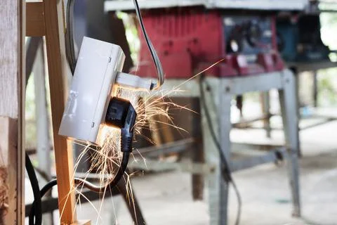 A short circuit causes a spark at the plug. Using non-standard power outlets  Fotos de archivo