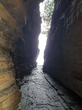 A short cut between cliffs out to sea. Stock Photos