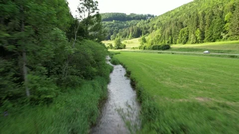 Short flight above a small river on the Schwäbische Alb of south Germany 4k Stockbeeldmateriaal 156347518