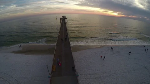 Short flight backwards over a pier viewing sunset. Stock Footage 90563150