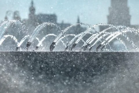 Short focus at the jets and splashes of the fountain in the back sunlight in  Stock Photos