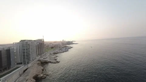 A short FPV drone flight along the shore with skyscrapers RAW video Stock Footage 248783972