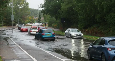 A short full HD video clip of cars negotiating a section of flooded road in the Stock Footage 233594839