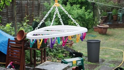 Short high definition clip of an empty washing line and pegs in a heavy rain Stock Footage 143024584