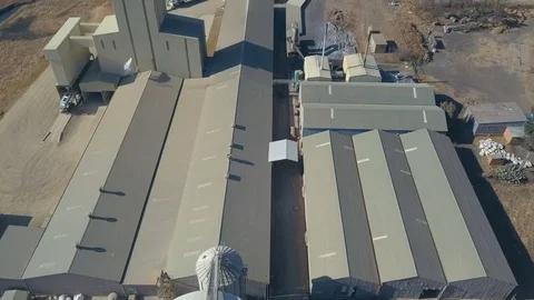 Short low flight over light industrial complex in African city Stock Footage 79806416