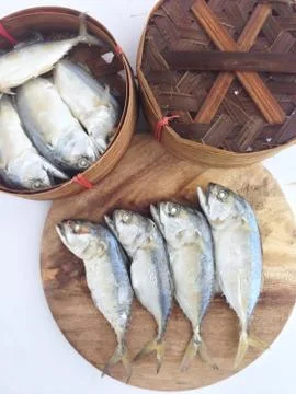 Short mackerel on cutting board with fish basket Stock Photos