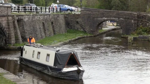 Short narrowboat moving along at Bugsworth Basin on the Peak Forest Canal. Video stock 86522326