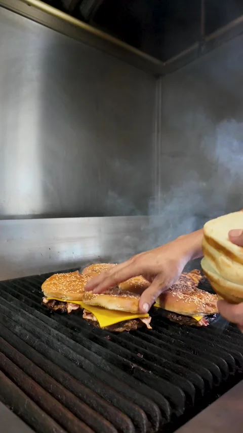 Short Order Cook Prepares Bacon Cheeseburgers at Roadside Diner - vertical Stock Footage 337875884