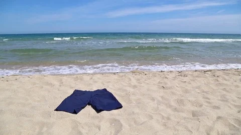 Short pants on the beach 스톡 동영상 75779369