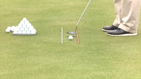 Short putt lips out while using golf alignment sticks Stock Footage 80509323