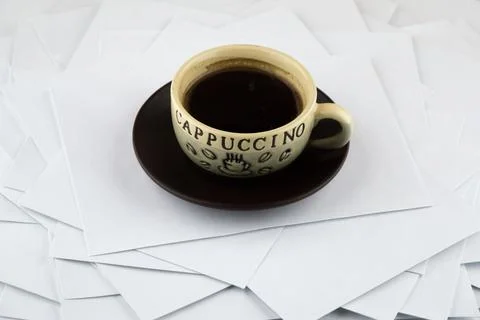 Short rest at the hard worker: a Cup of hot coffee and a brown ceramic saucer Stock Photos