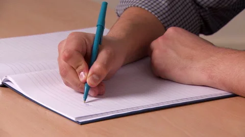 Short Shot of Someone Writing in a Notebook Stock Footage 48497802