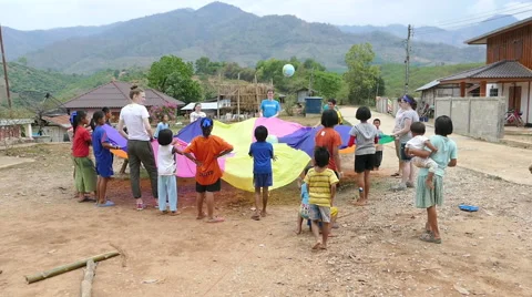 Short-Term Missions Team Playing Parachute Games With Kids Stock Footage 49088766