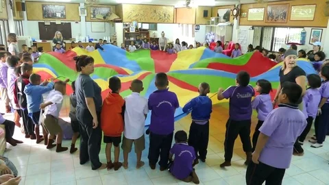 Short Term Missions Team Uses Parachute In School With Kids Stock Footage 83730154