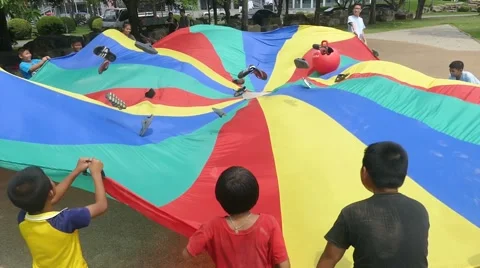 Short Term Missions Team Using Parachute With Asian Children Stock Footage 61572491