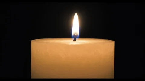 A short time-lapse of a burning candle. shot in the dark to create a Stock Footage 99474305