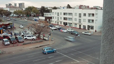 A short time-lapse of moving traffic along an intersection in the C.B.D 動画素材 114104788
